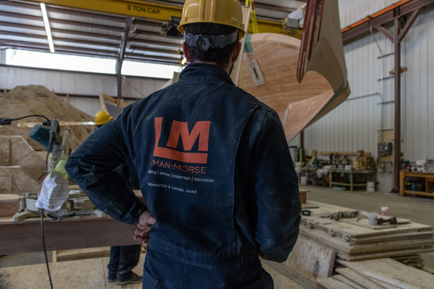 Lyman-Morse boatbuilding with worker observing manufacturing process