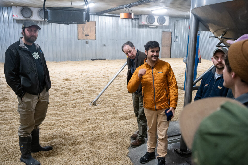 Team in storage space looking at large amounts of grain
