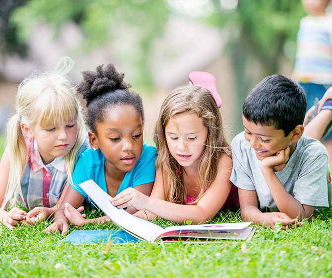 Children reading book together