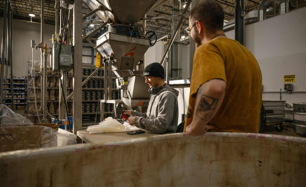 Close view of workers packing grow kit materials