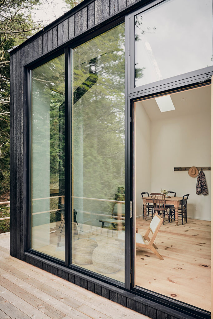 Exterior shot of interior living room through large glass doors