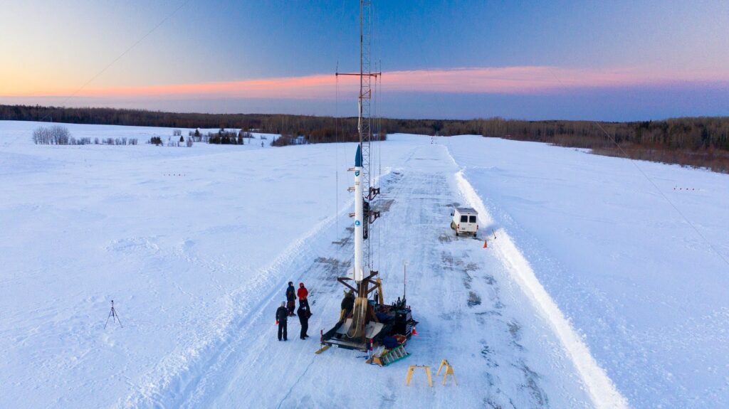 team observing rocket before launch