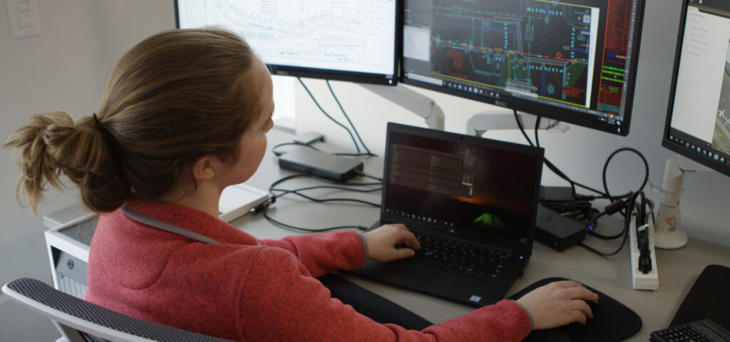 Woman overlooking data on computer screen