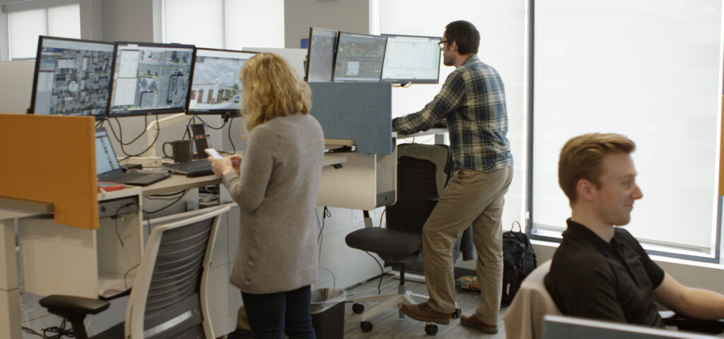 Tilson employees at work, looking at monitors