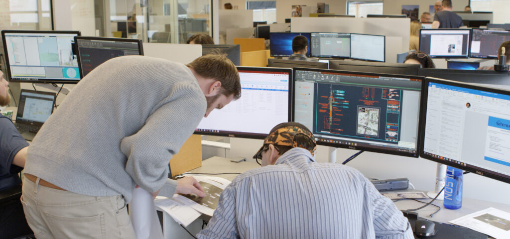 Tilson Employees looking at data on screen and on paper